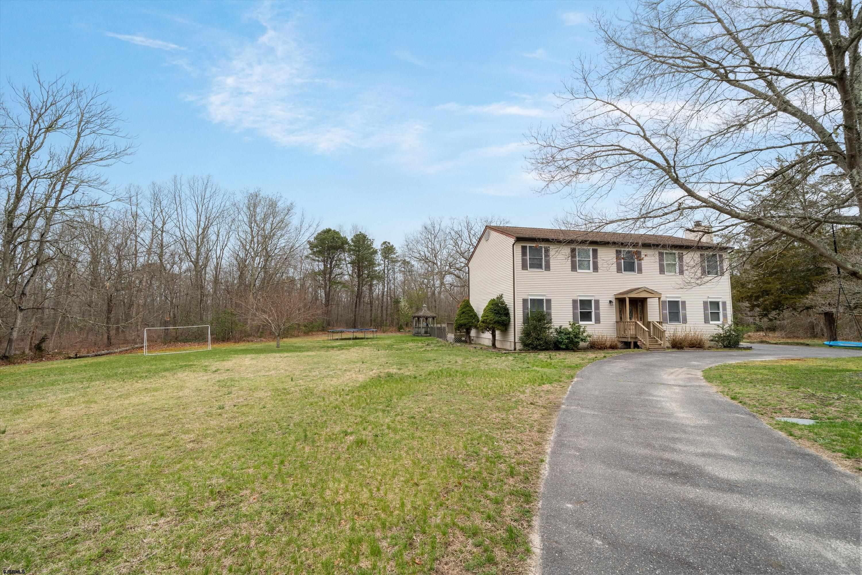 1319 Somers Point Road Egg Harbor Township, NJ 08234 - Photo 17 of 83 a front view of a house with a yard and trees