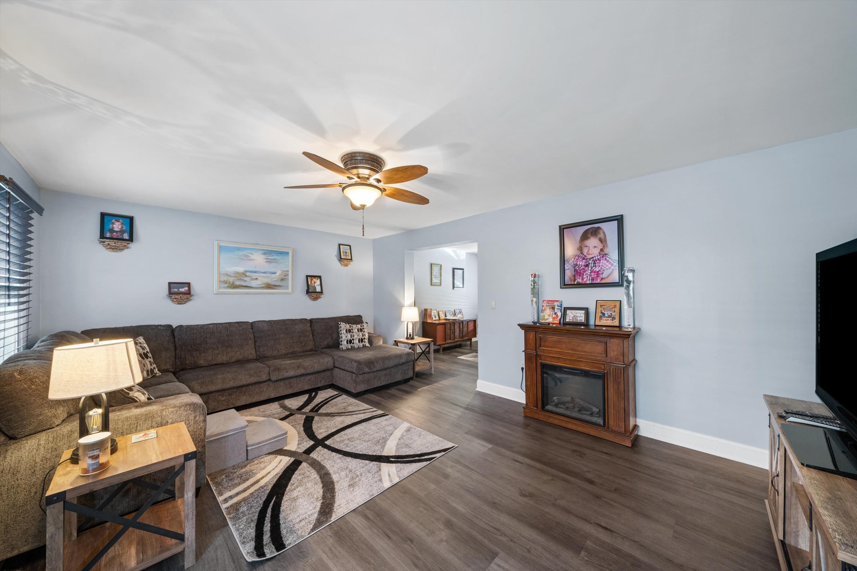 1319 Somers Point Road Egg Harbor Township, NJ 08234 - Photo 23 of 83 a living room with furniture and a flat screen tv with wooden floor