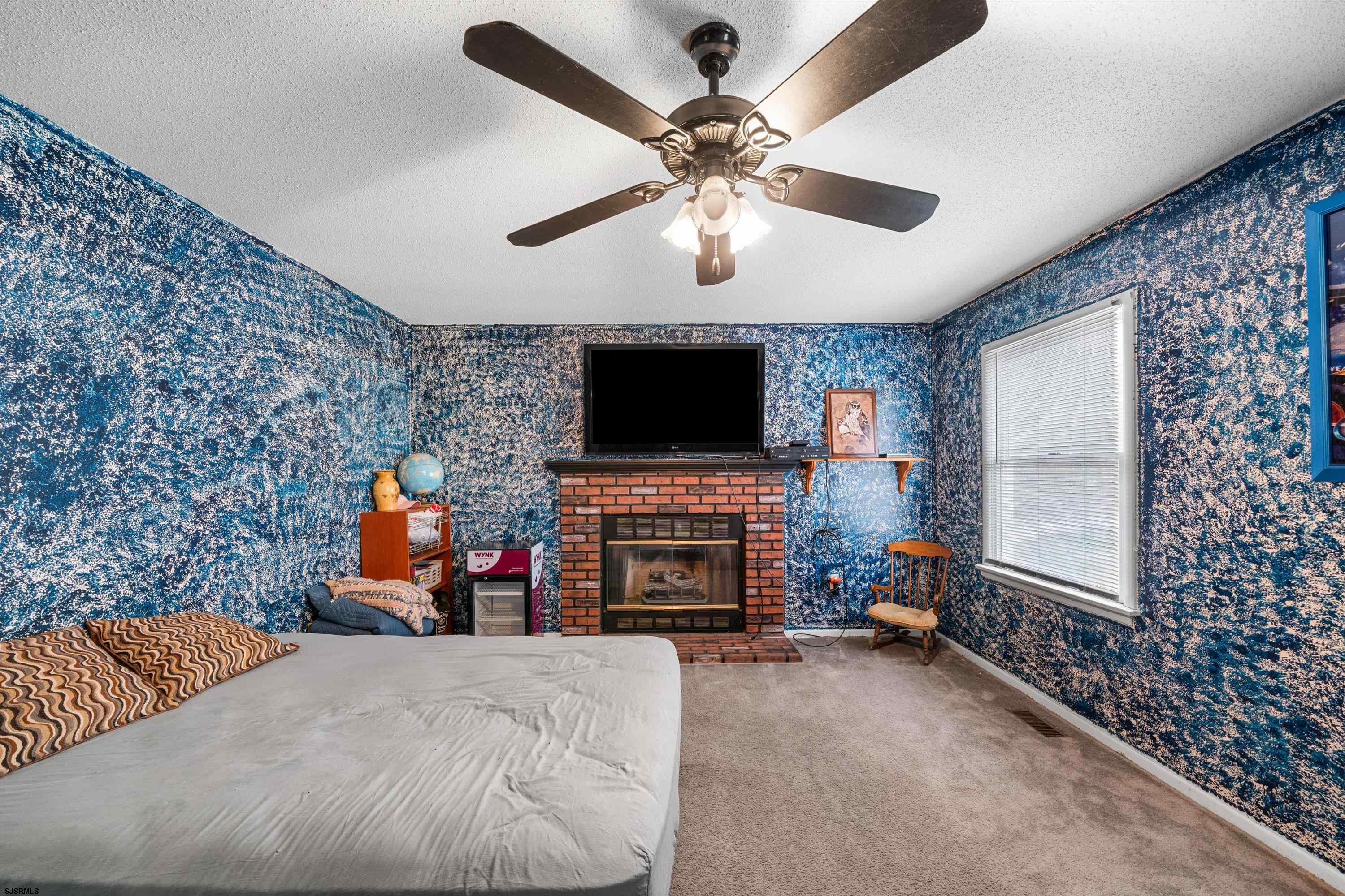 1319 Somers Point Road Egg Harbor Township, NJ 08234 - Photo 32 of 83 a living room with furniture a fireplace and a flat screen tv