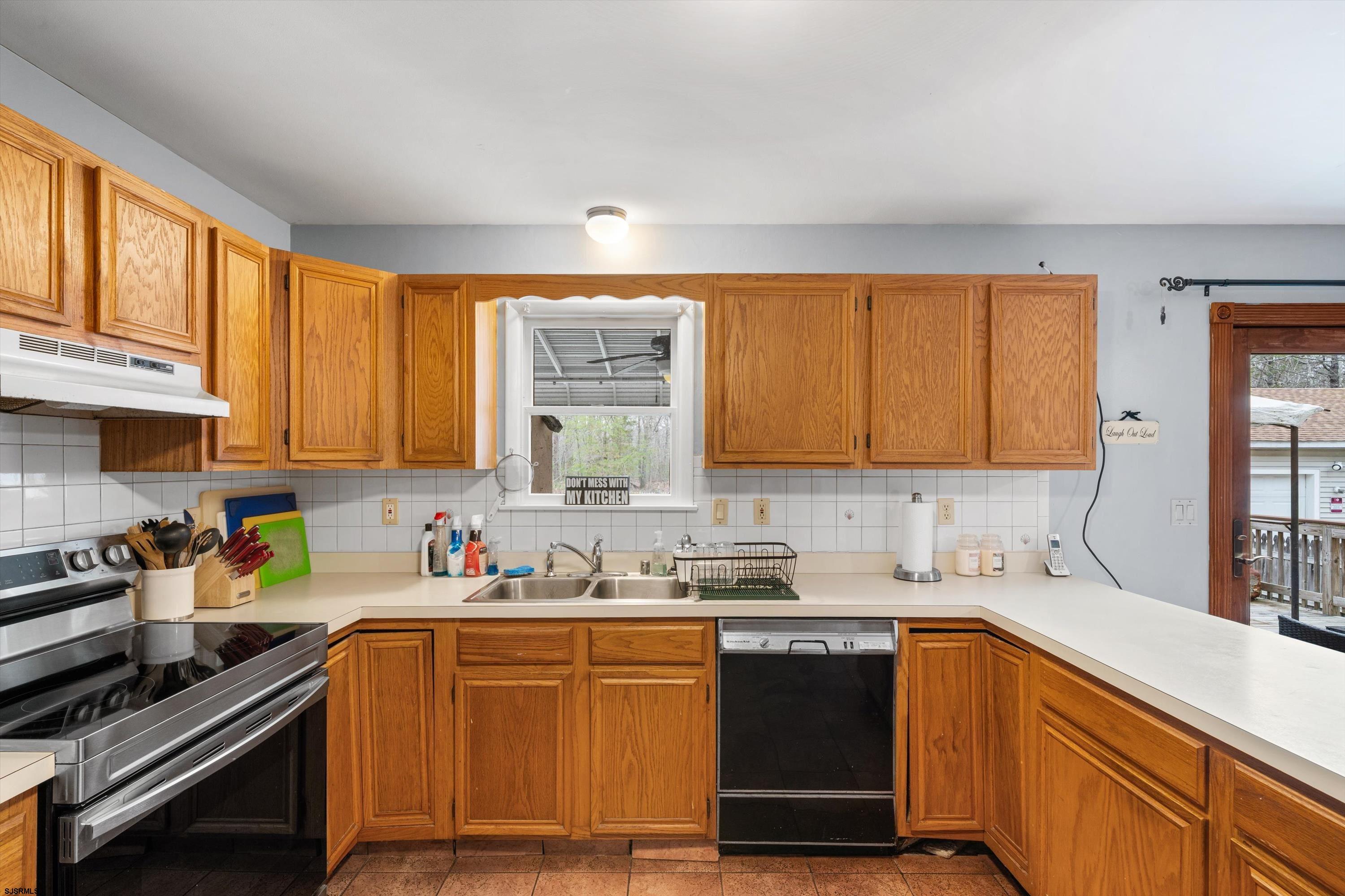 1319 Somers Point Road Egg Harbor Township, NJ 08234 - Photo 41 of 83 a kitchen with stainless steel appliances granite countertop a sink stove and cabinets