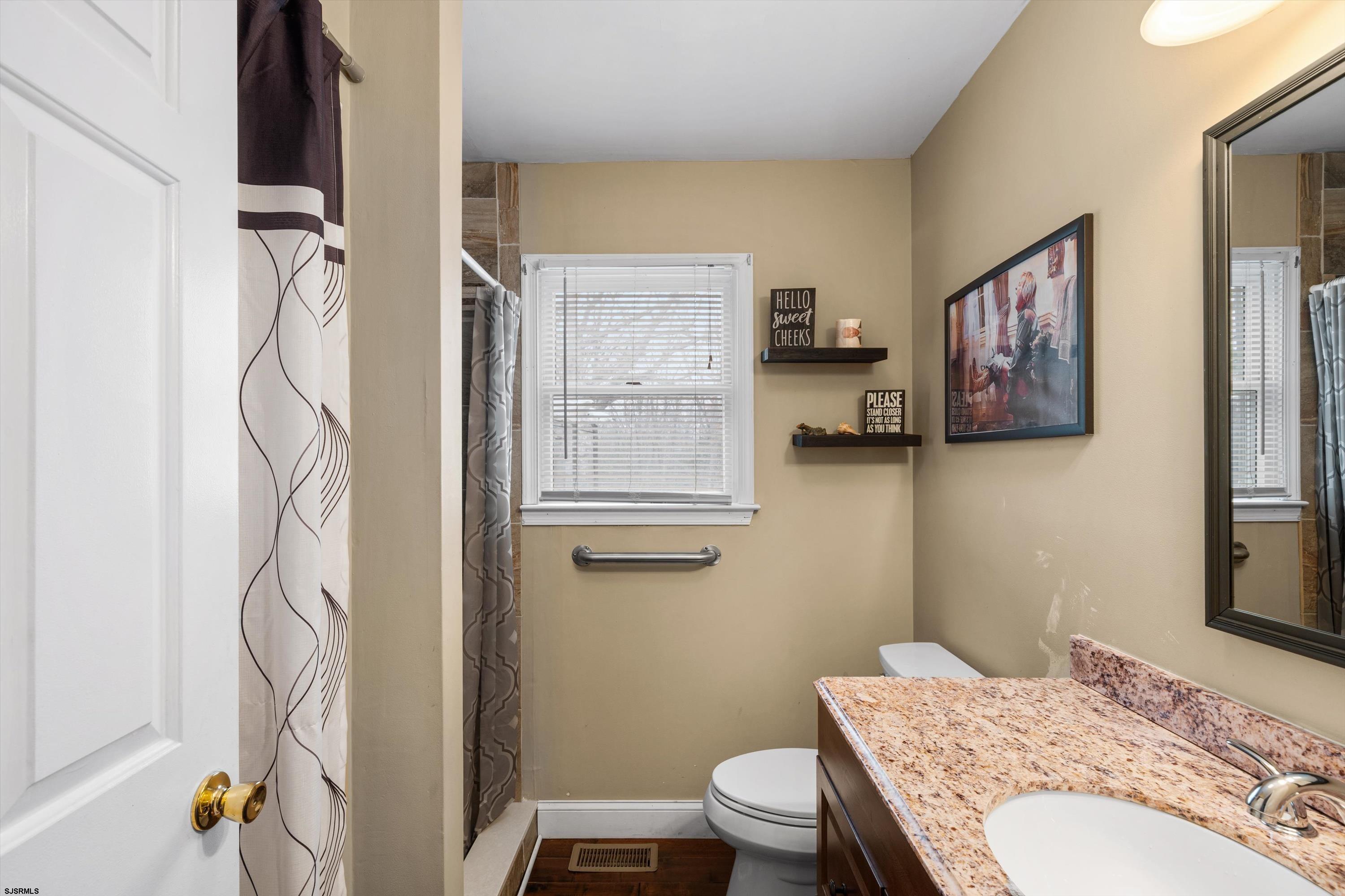 1319 Somers Point Road Egg Harbor Township, NJ 08234 - Photo 44 of 83 a bathroom with a granite countertop sink a toilet and a shower