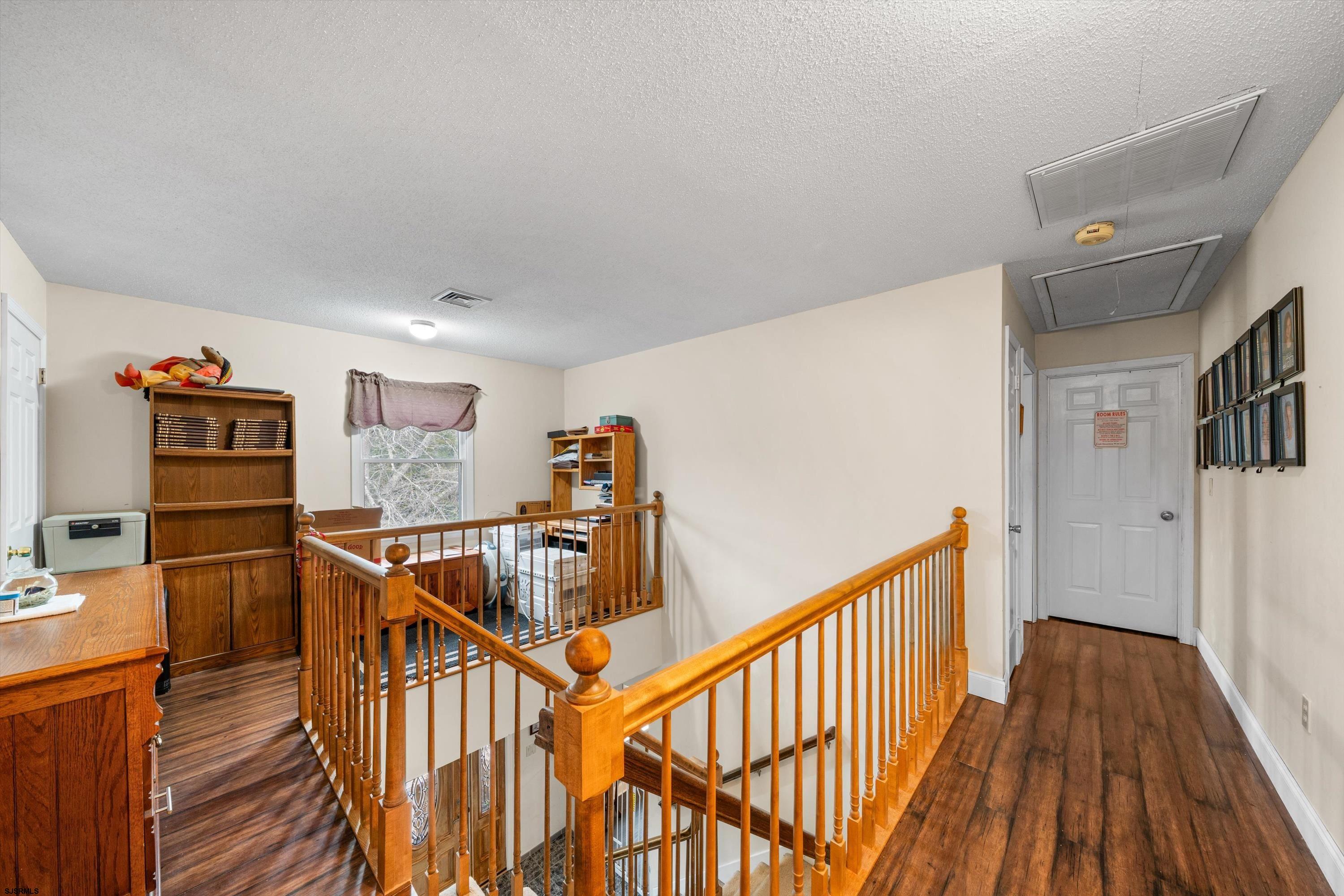 1319 Somers Point Road Egg Harbor Township, NJ 08234 - Photo 47 of 83 a view of a hallway with wooden floor and stairs