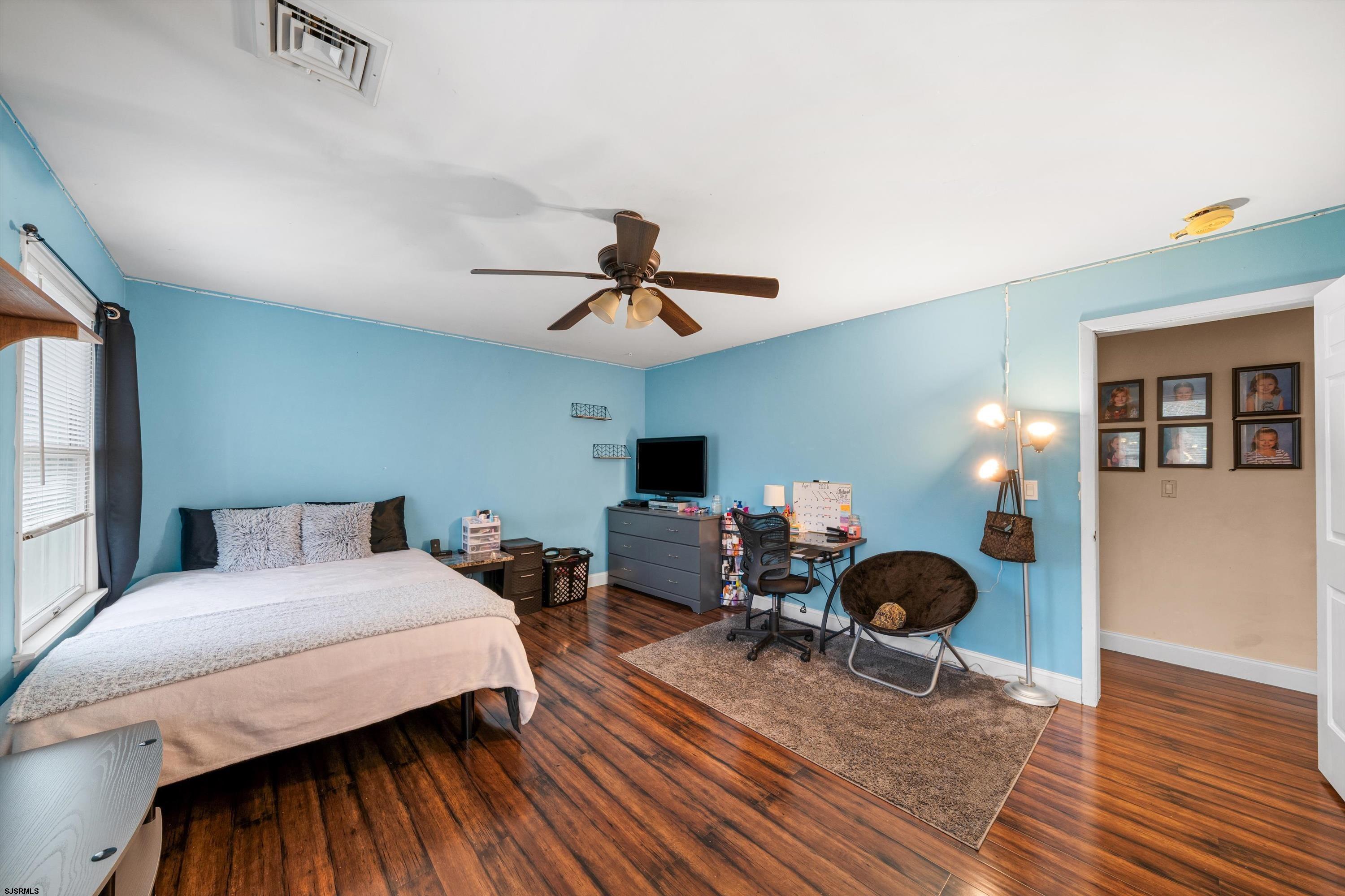 1319 Somers Point Road Egg Harbor Township, NJ 08234 - Photo 58 of 83 a bedroom with a bed and wooden floor