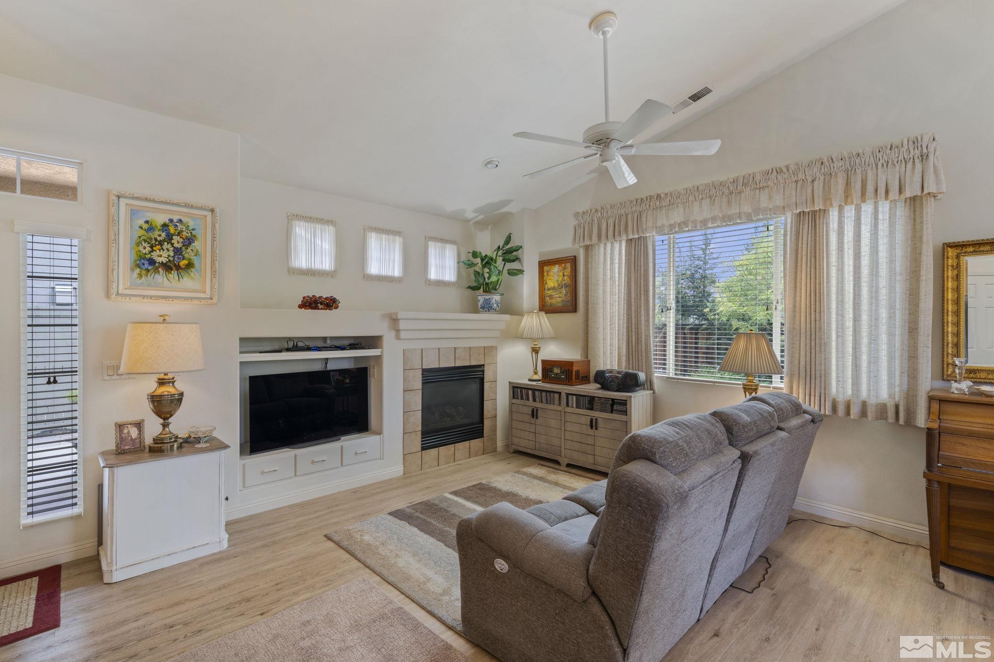 1620 Rocky Cove Lane Reno, NV 89521 - Photo 9 of 35 a living room with furniture a fireplace and a window