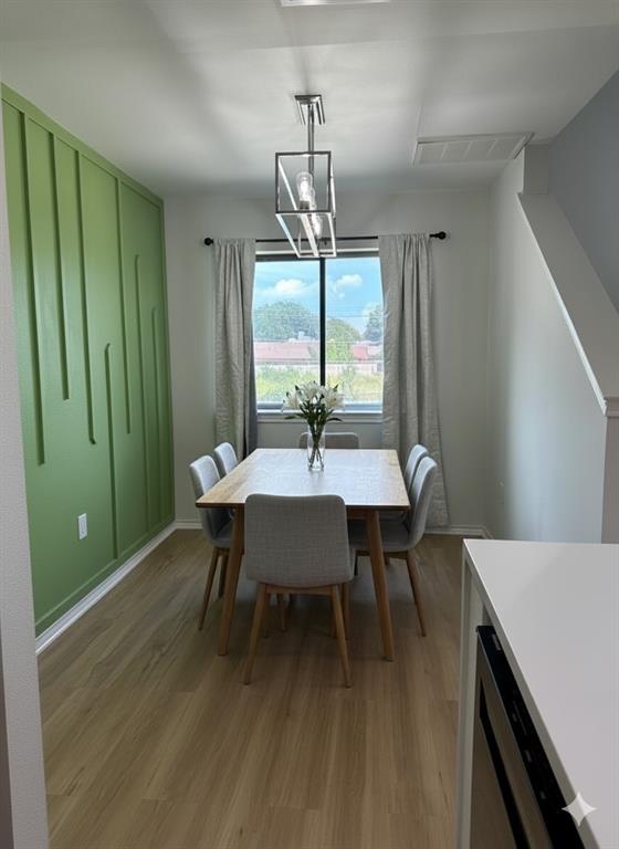 9837 Walnut Street, Unit 207 Dallas, TX 75243 - Photo 2 of 10 a dining room with furniture a chandelier and wooden floor