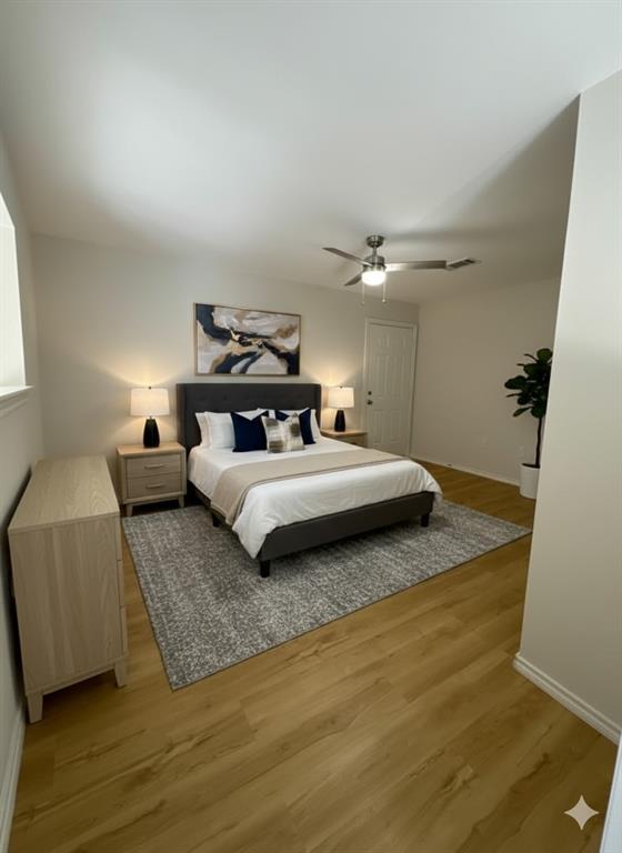 9837 Walnut Street, Unit 207 Dallas, TX 75243 - Photo 7 of 10 a bedroom with a bed and wooden floor