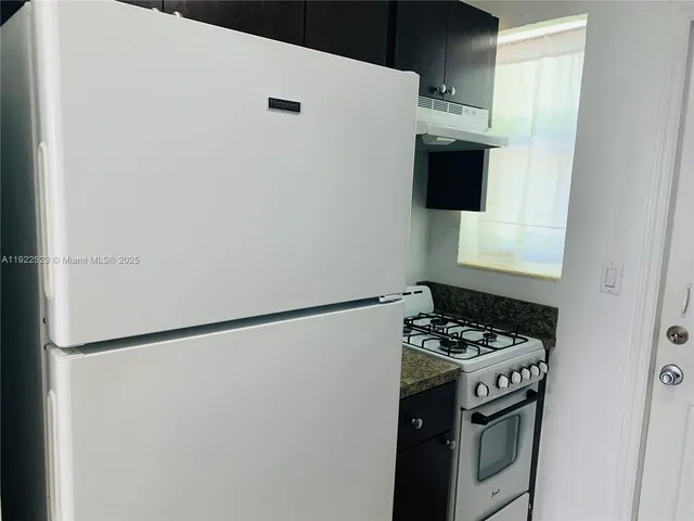a white refrigerator freezer sitting inside of a kitchen