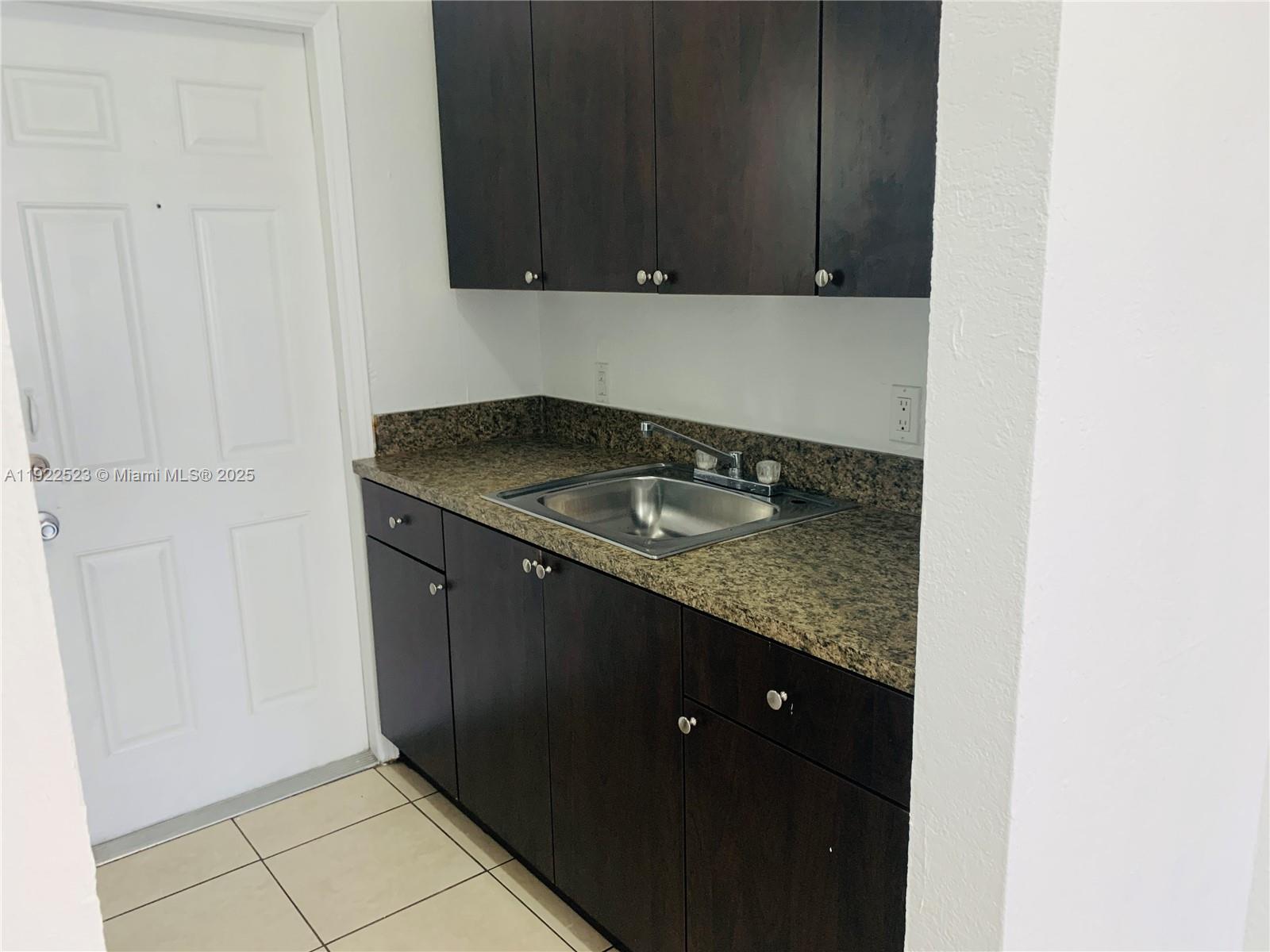 1265 Southwest 6th Street, Unit 10 Miami, FL 33135 - Photo 2 of 6 a kitchen with a sink and cabinets