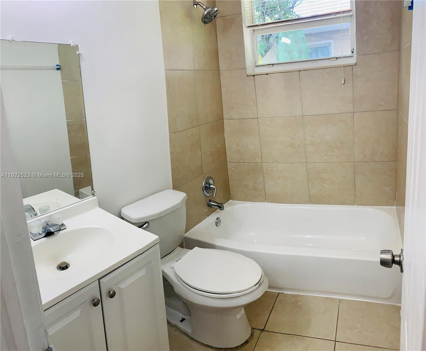 1265 Southwest 6th Street, Unit 10 Miami, FL 33135 - Photo 6 of 6 a bathroom with a sink a toilet and shower