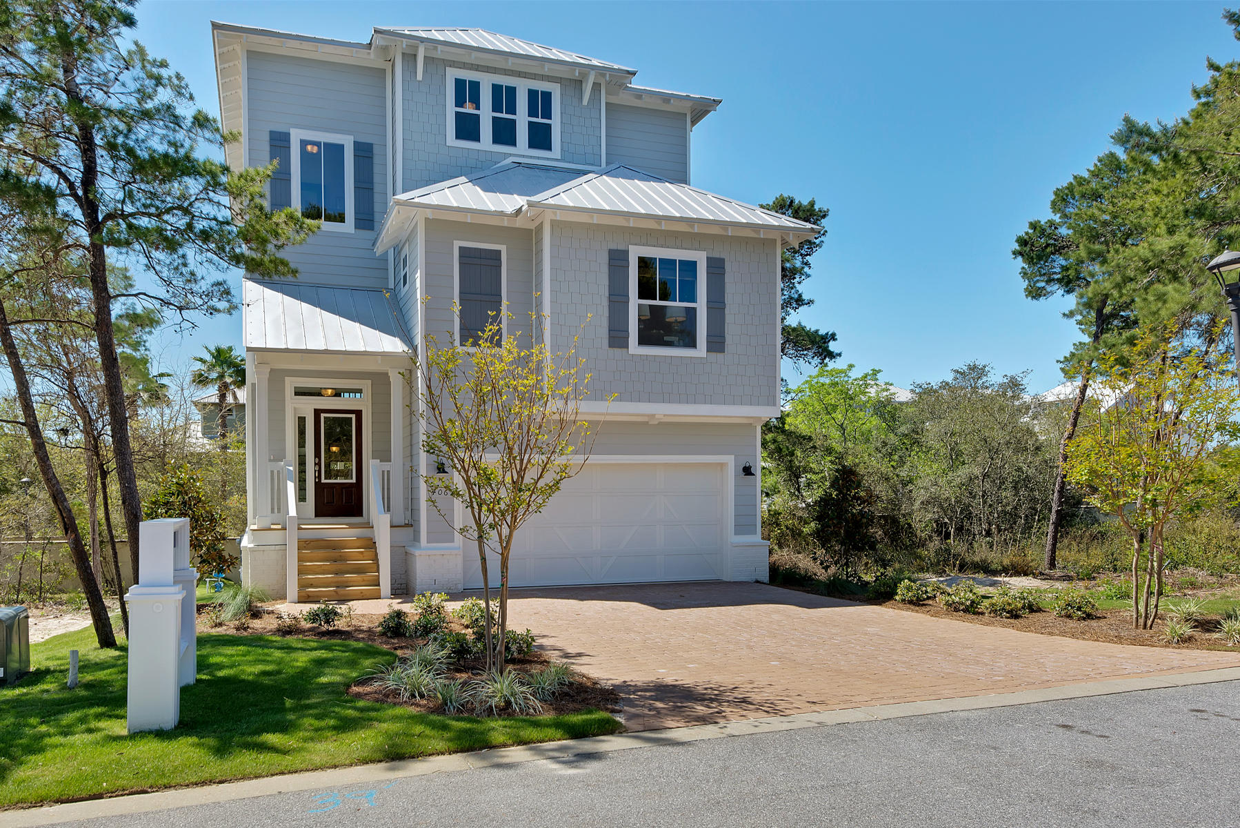 Lot 21 Grande Pointe Cir Inlet Beach Inlet Beach, FL 32461 - Photo 1 of 16 a front view of a house with a yard and garage