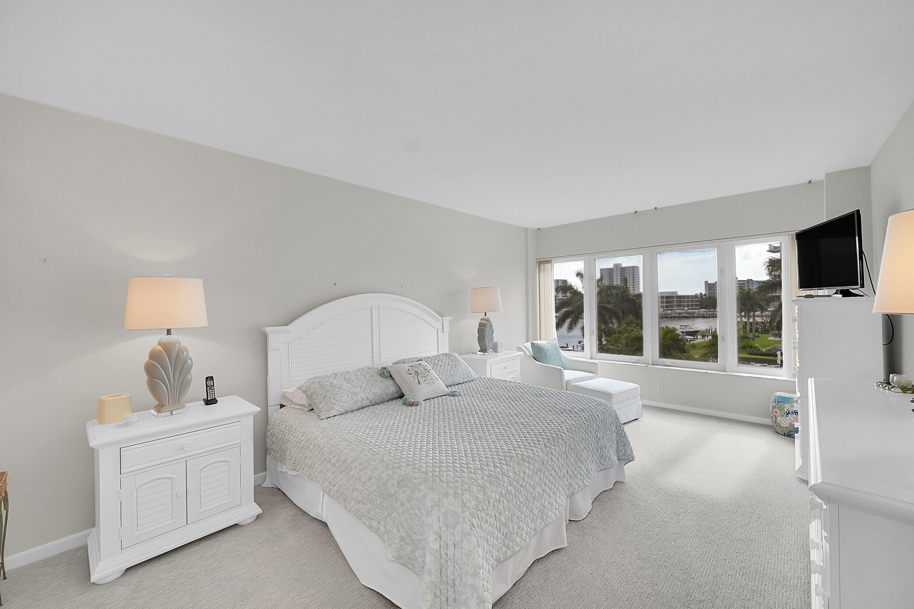 701 East Camino Real, Unit 4B Boca Raton, FL 33432 - Photo 18 of 35 a bedroom with a large bed and a large window