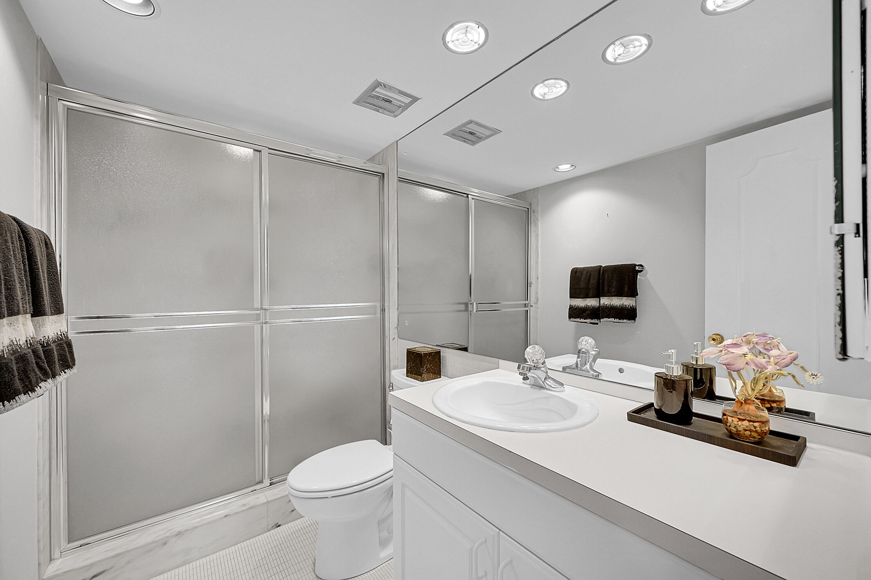 701 East Camino Real, Unit 4B Boca Raton, FL 33432 - Photo 22 of 35 a bathroom with a sink a toilet and shower