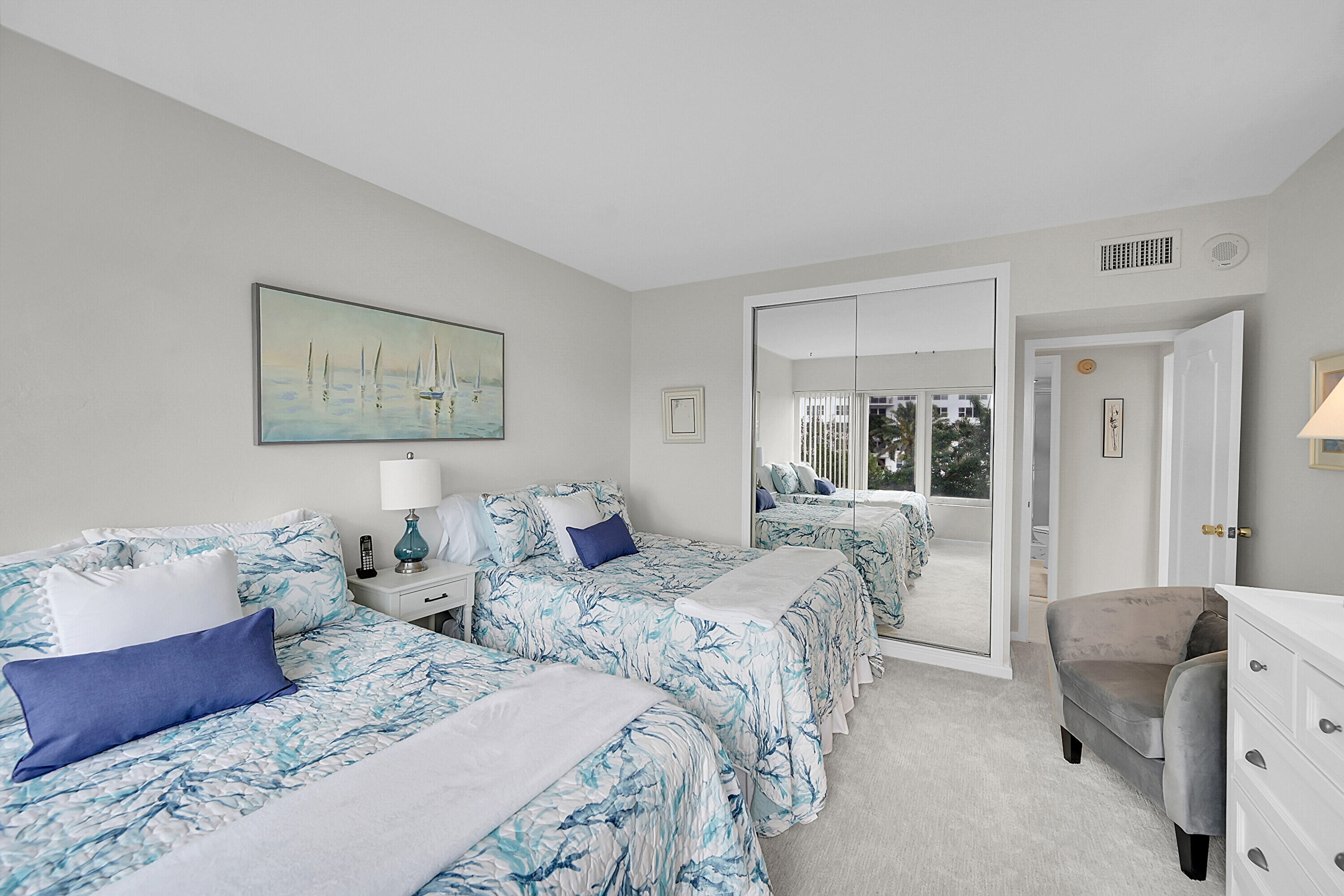 701 East Camino Real, Unit 4B Boca Raton, FL 33432 - Photo 25 of 35 a bedroom with two beds and a large mirror