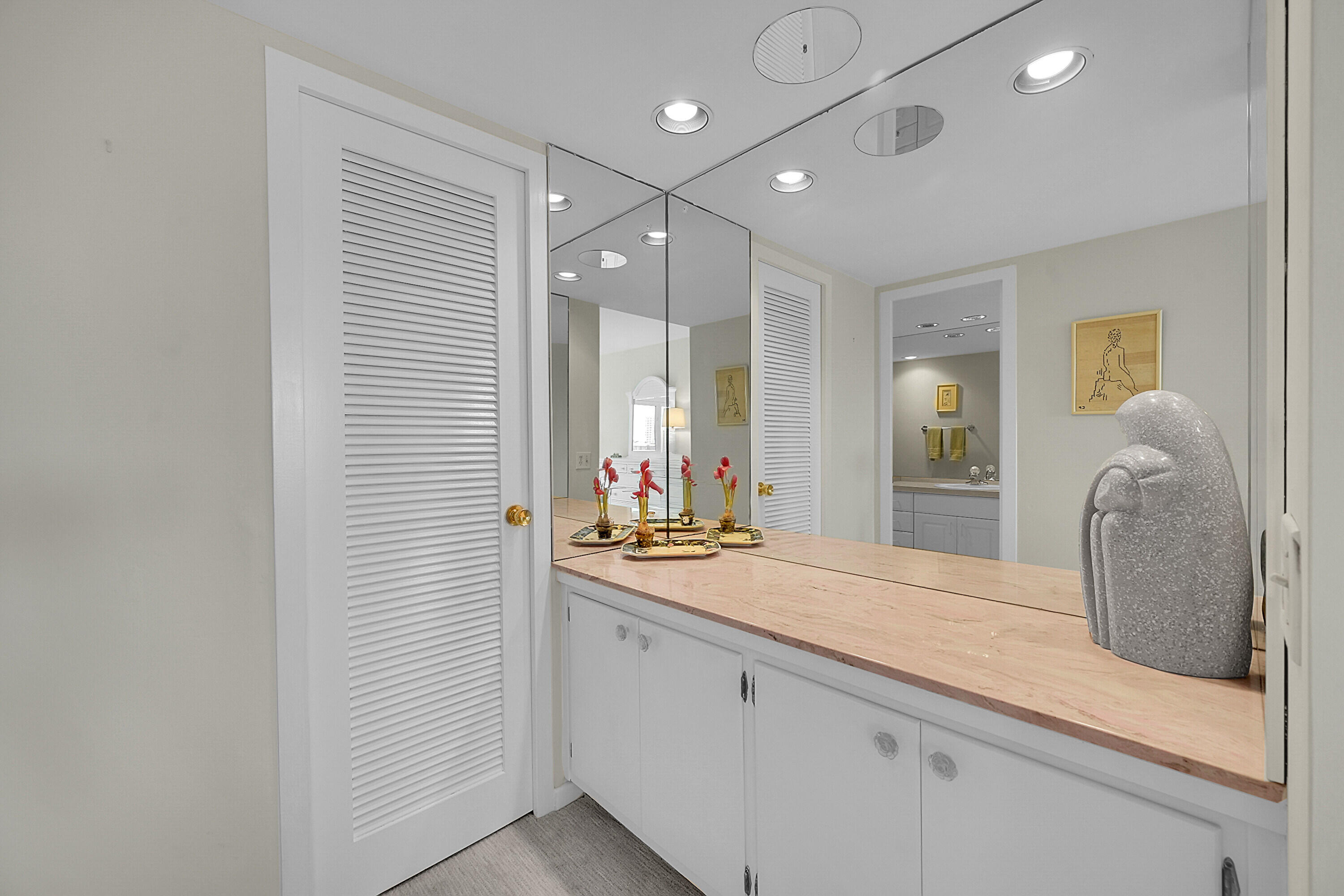 701 East Camino Real, Unit 4B Boca Raton, FL 33432 - Photo 27 of 35 a bathroom with a sink and a mirror