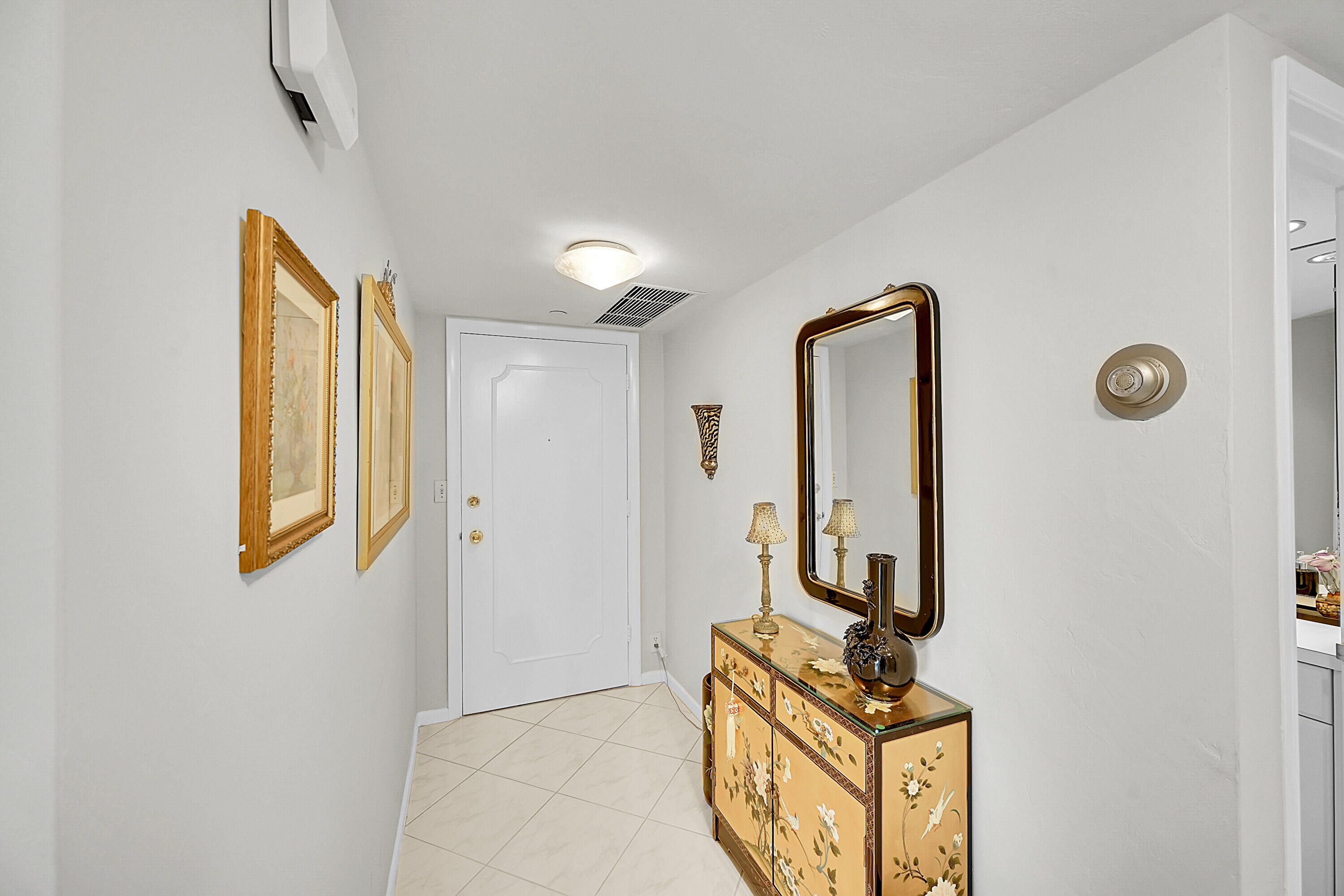 701 East Camino Real, Unit 4B Boca Raton, FL 33432 - Photo 6 of 35 a view of an entryway with wooden floor