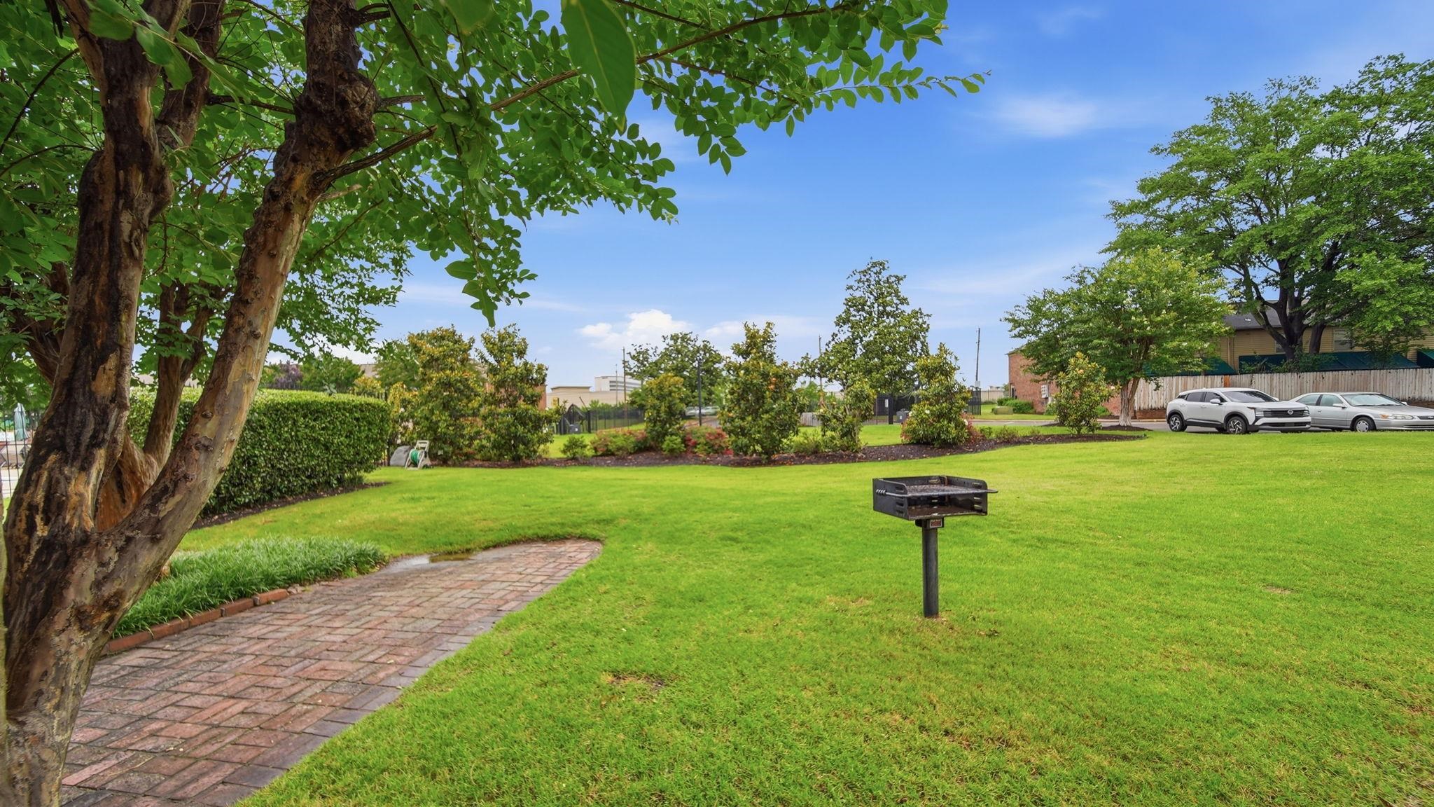 5866 Roxbury Drive, Unit 5866 Memphis, TN 38119 - Photo 19 of 20 Expansive lawn area featuring a built-in barbecue grill