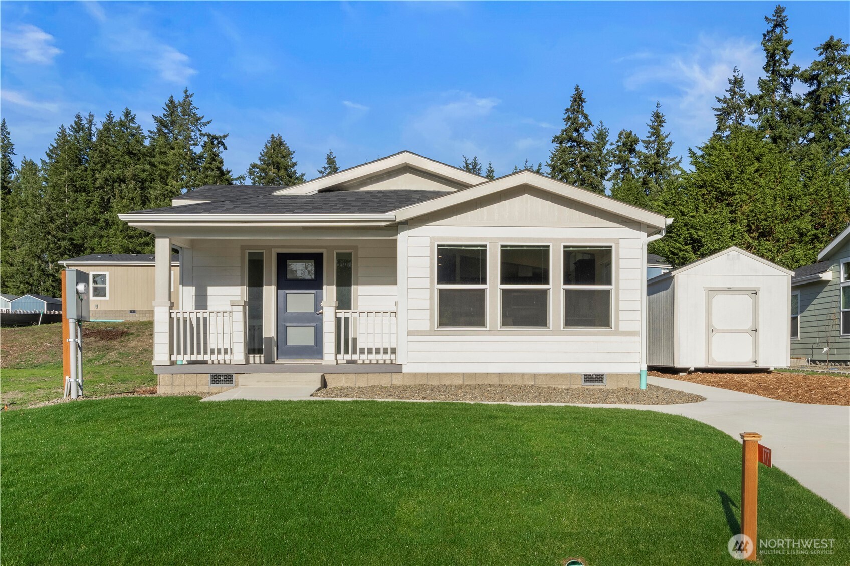 a front view of a house with a garden