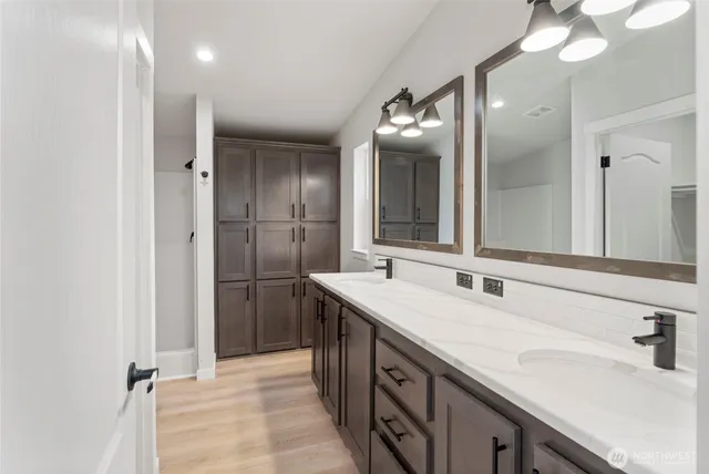 a bathroom with a double vanity sink mirror and double