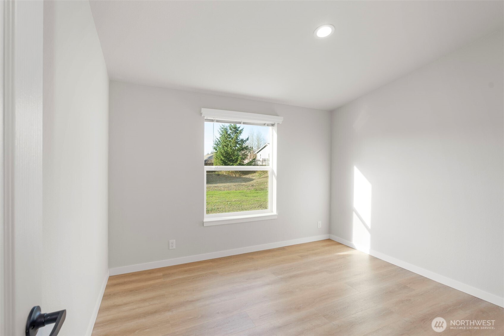 177 Sunset Meadows Lane Port Hadlock, WA 98339 - Photo 16 of 20 an empty room with wooden floor and windows