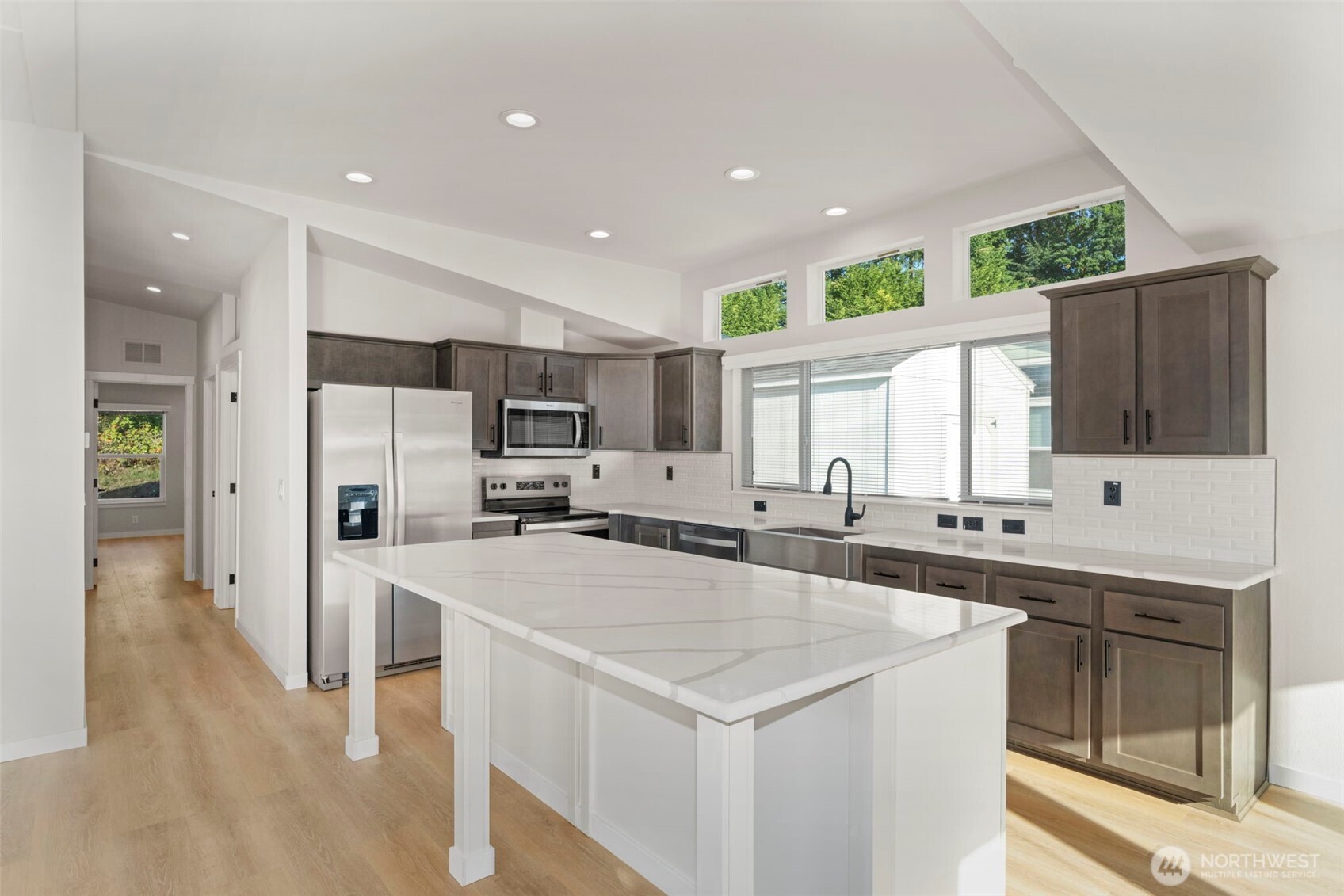 177 Sunset Meadows Lane Port Hadlock, WA 98339 - Photo 10 of 20 a kitchen with stainless steel appliances a sink a stove a refrigerator cabinets and wooden floor