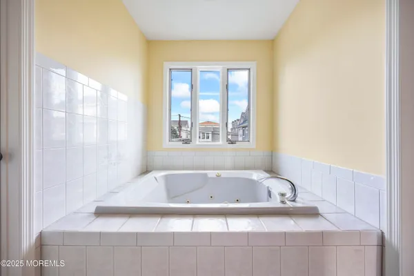 a bathroom with bathtub and window