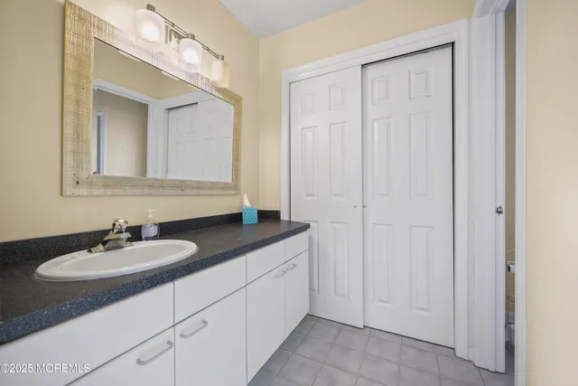 a bedroom with a bed chandelier and a window