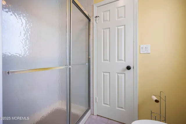 a bathroom with bathtub and window