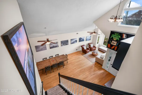 a bedroom with a bed chandelier and a window