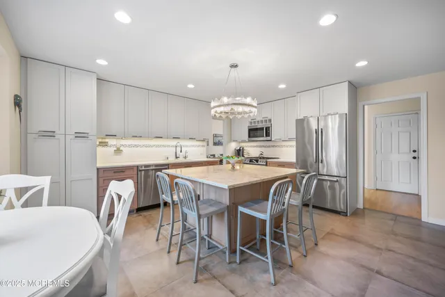 a living room with furniture and a view of kitchen