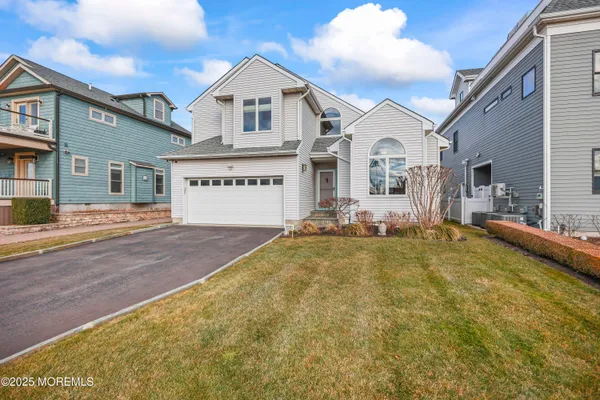 a large kitchen with kitchen island a large counter top space a sink stainless steel appliances and cabinets