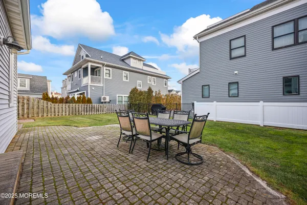 a kitchen with kitchen island a appliances dining table and chairs