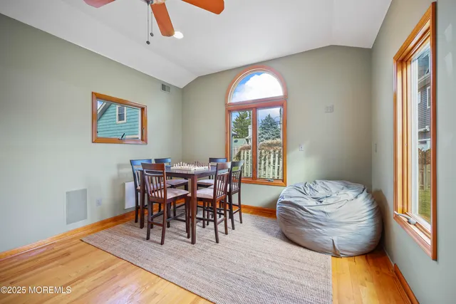 a view of a dining room with furniture and wooden floor