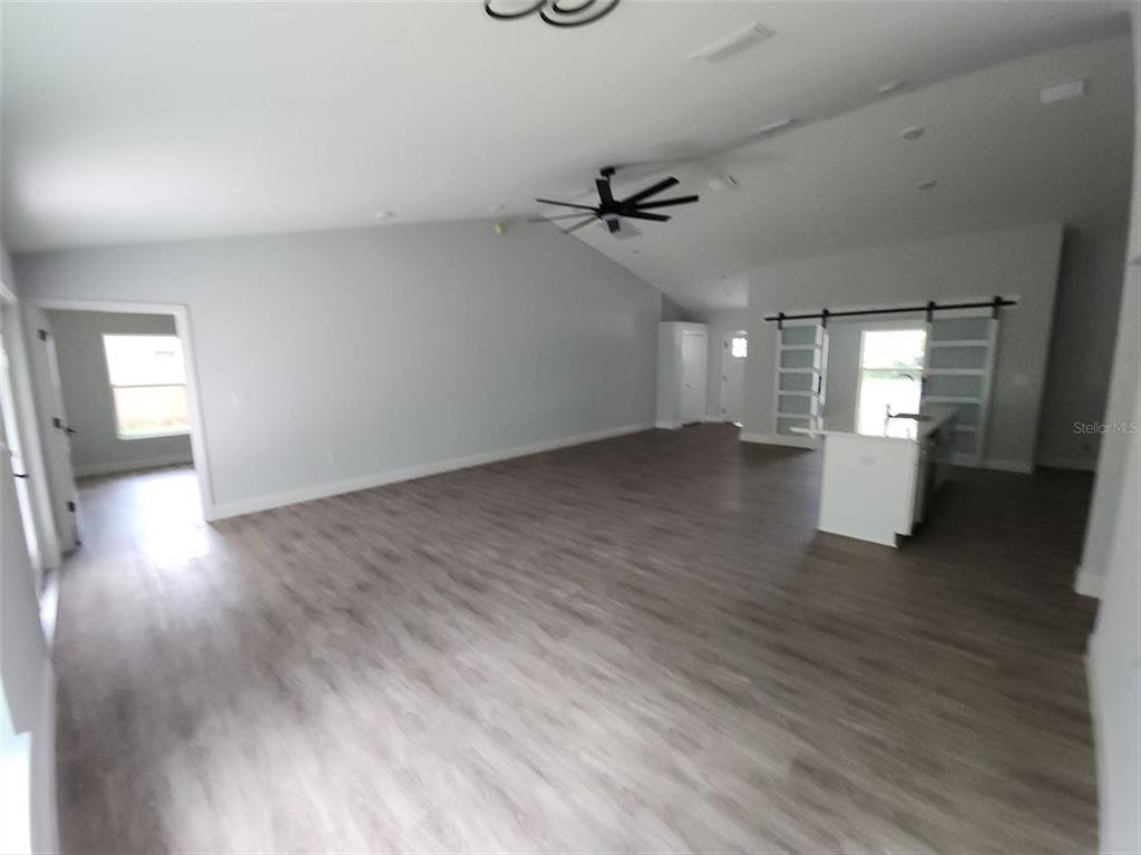 1111 Dagmar Avenue Spring Hill, FL 34606 - Photo 27 of 27 a view of empty room with wooden floor and window