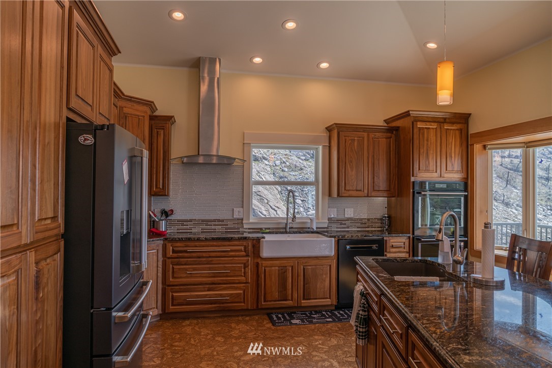70 B Tunk Creek Road Riverside, WA 98849 - Photo 14 of 40 a kitchen with stainless steel appliances granite countertop a refrigerator and a stove
