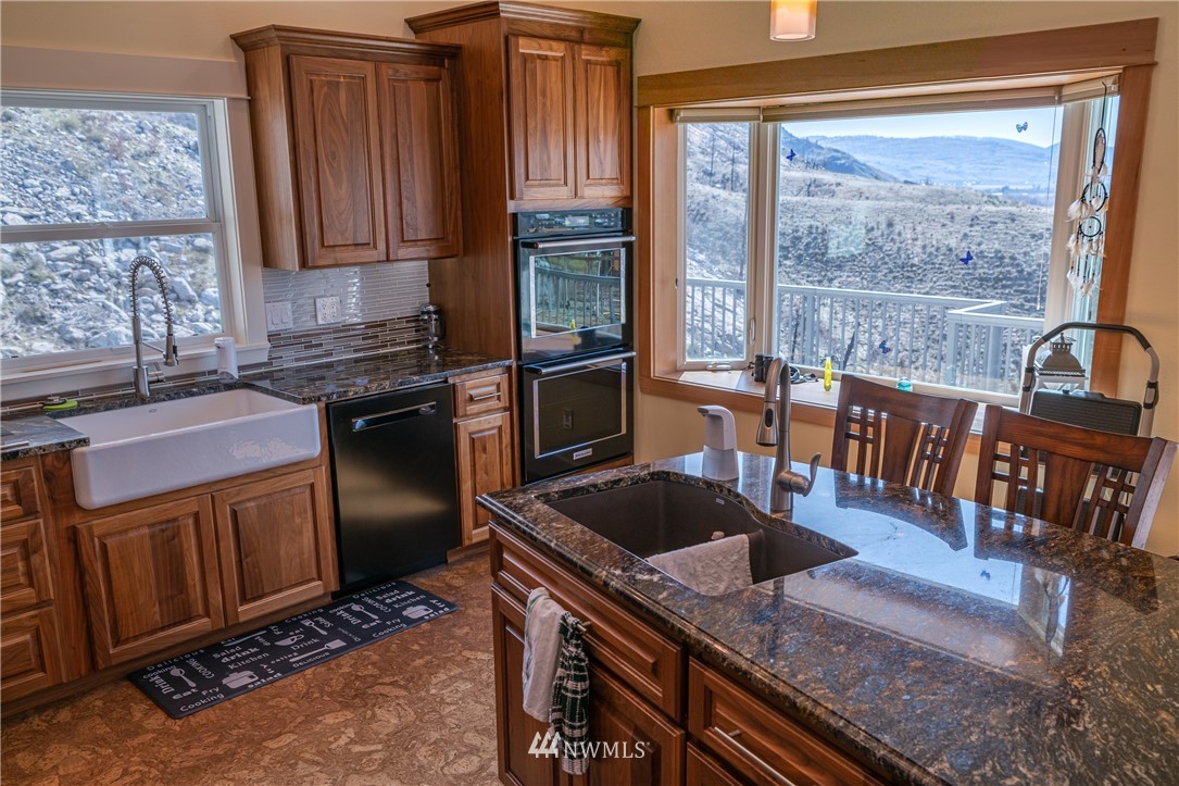 70 B Tunk Creek Road Riverside, WA 98849 - Photo 16 of 40 a kitchen with granite countertop a stove a sink and a refrigerator