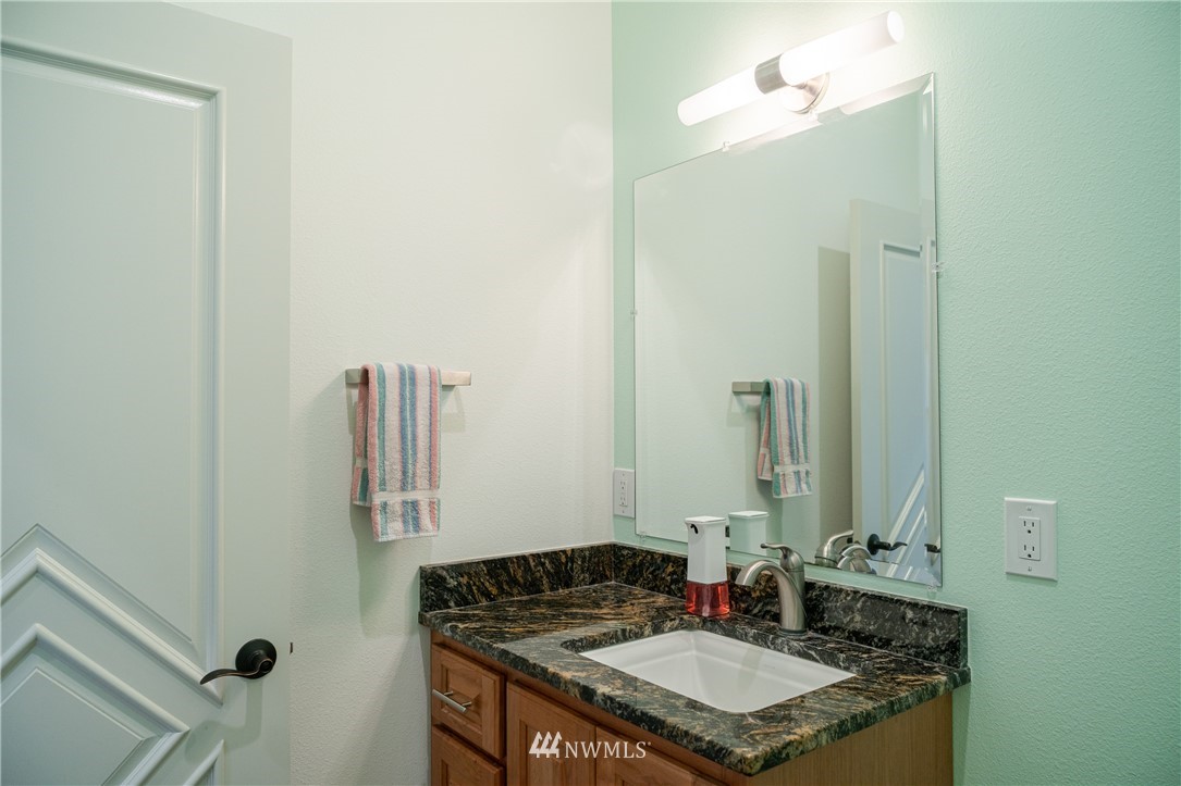 70 B Tunk Creek Road Riverside, WA 98849 - Photo 17 of 40 a bathroom with a granite countertop sink and a mirror