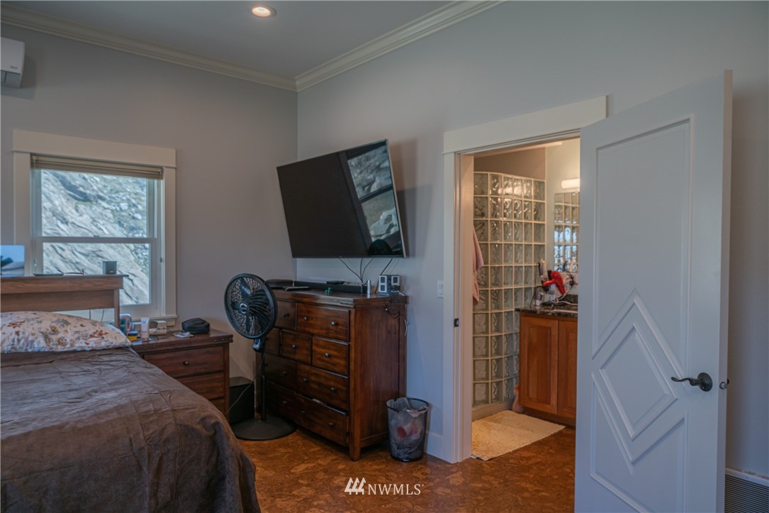70 B Tunk Creek Road Riverside, WA 98849 - Photo 20 of 40 a bedroom with a bed and flat screen tv