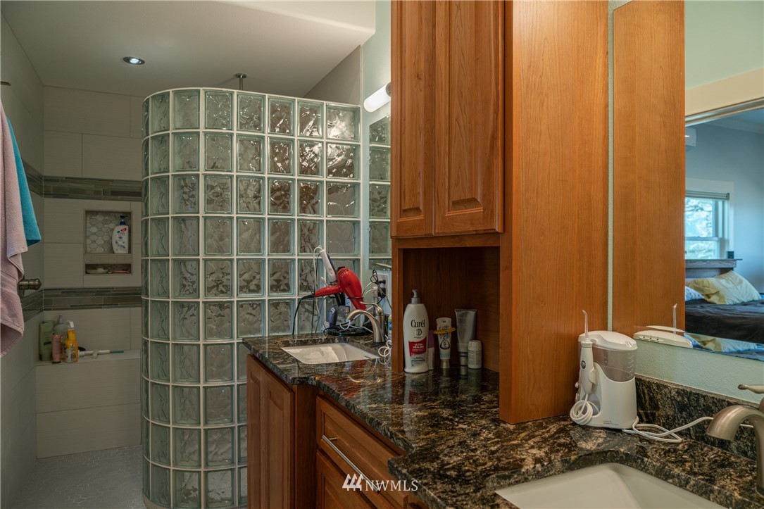 70 B Tunk Creek Road Riverside, WA 98849 - Photo 21 of 40 a bathroom with a granite countertop sink a mirror and shower