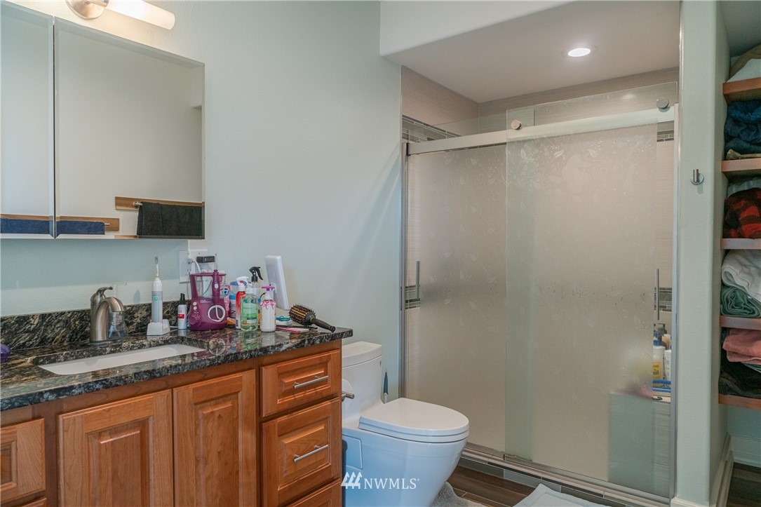 70 B Tunk Creek Road Riverside, WA 98849 - Photo 29 of 40 a bathroom with a granite countertop sink toilet and shower