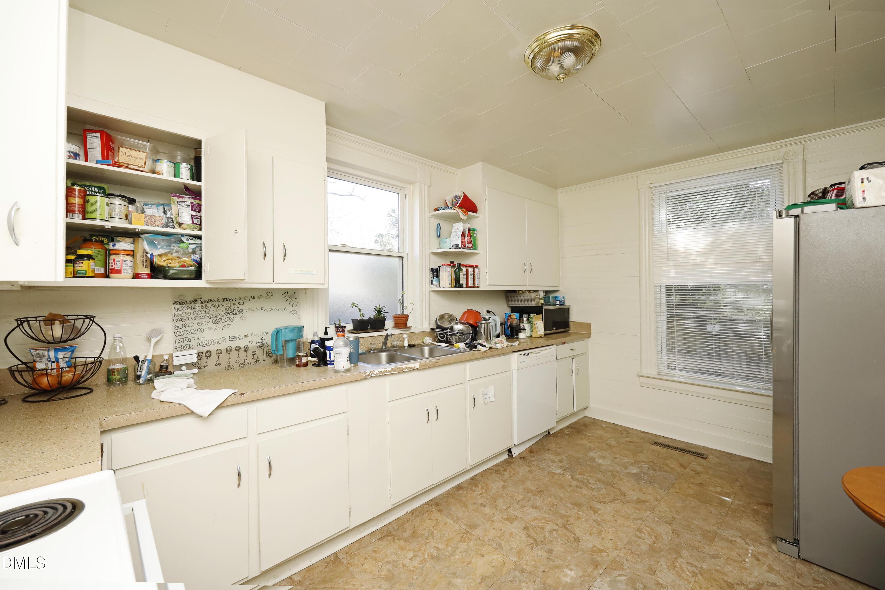 822 Clarendon Street Durham, NC 27705 - Photo 2 of 8 a kitchen with a sink cabinets and window