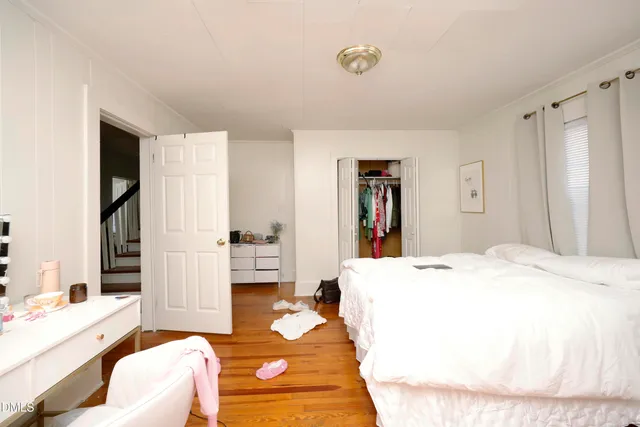 a bedroom with a bed and a couch