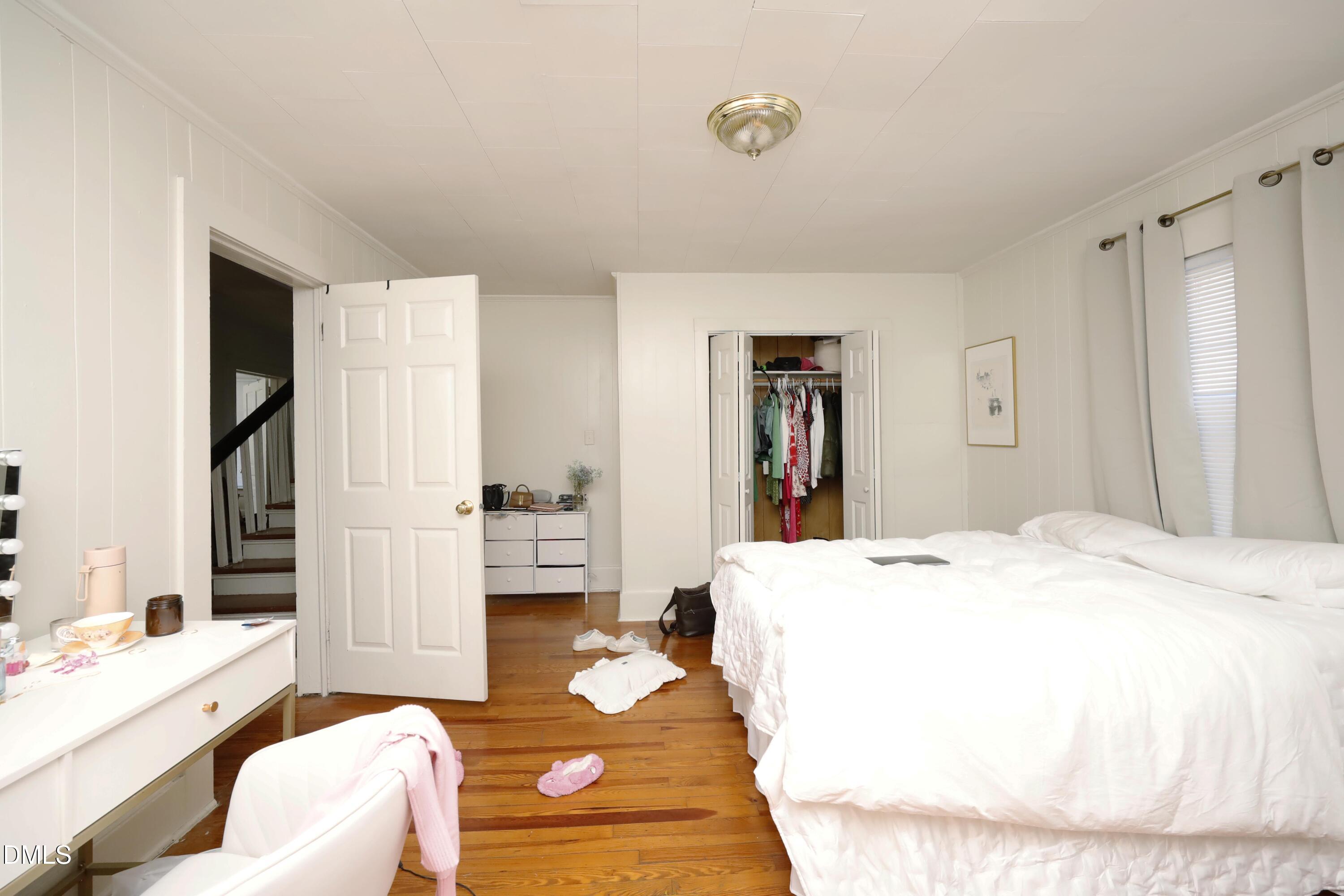 822 Clarendon Street Durham, NC 27705 - Photo 4 of 8 a bedroom with a bed and a couch