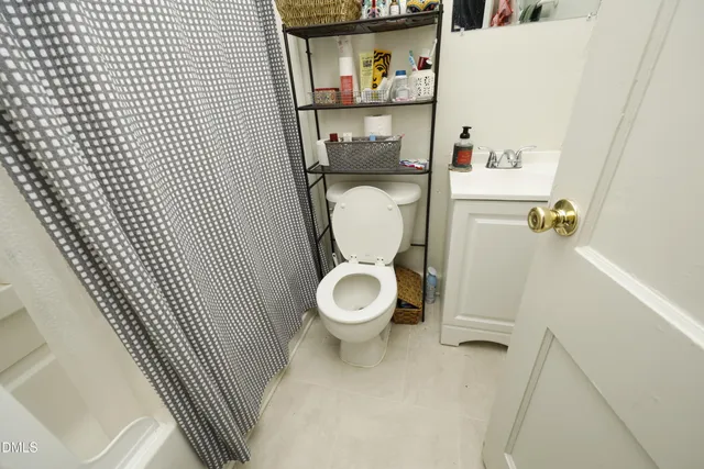 a white toilet sitting next to a bathroom sink