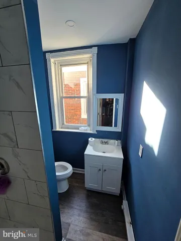 a bathroom with a toilet sink and mirror