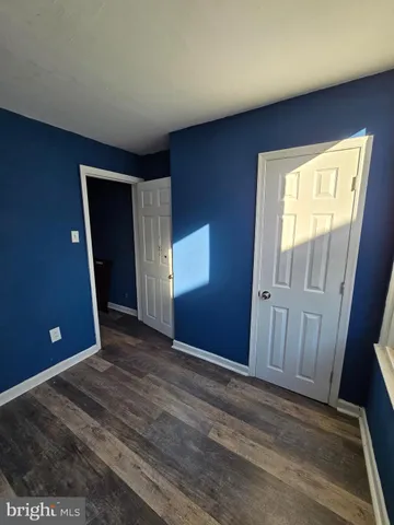 a view of a livingroom with wooden floor and chair