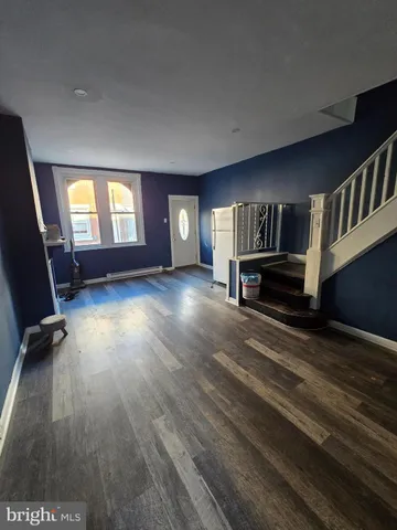 a view of a livingroom with hardwood and furniture