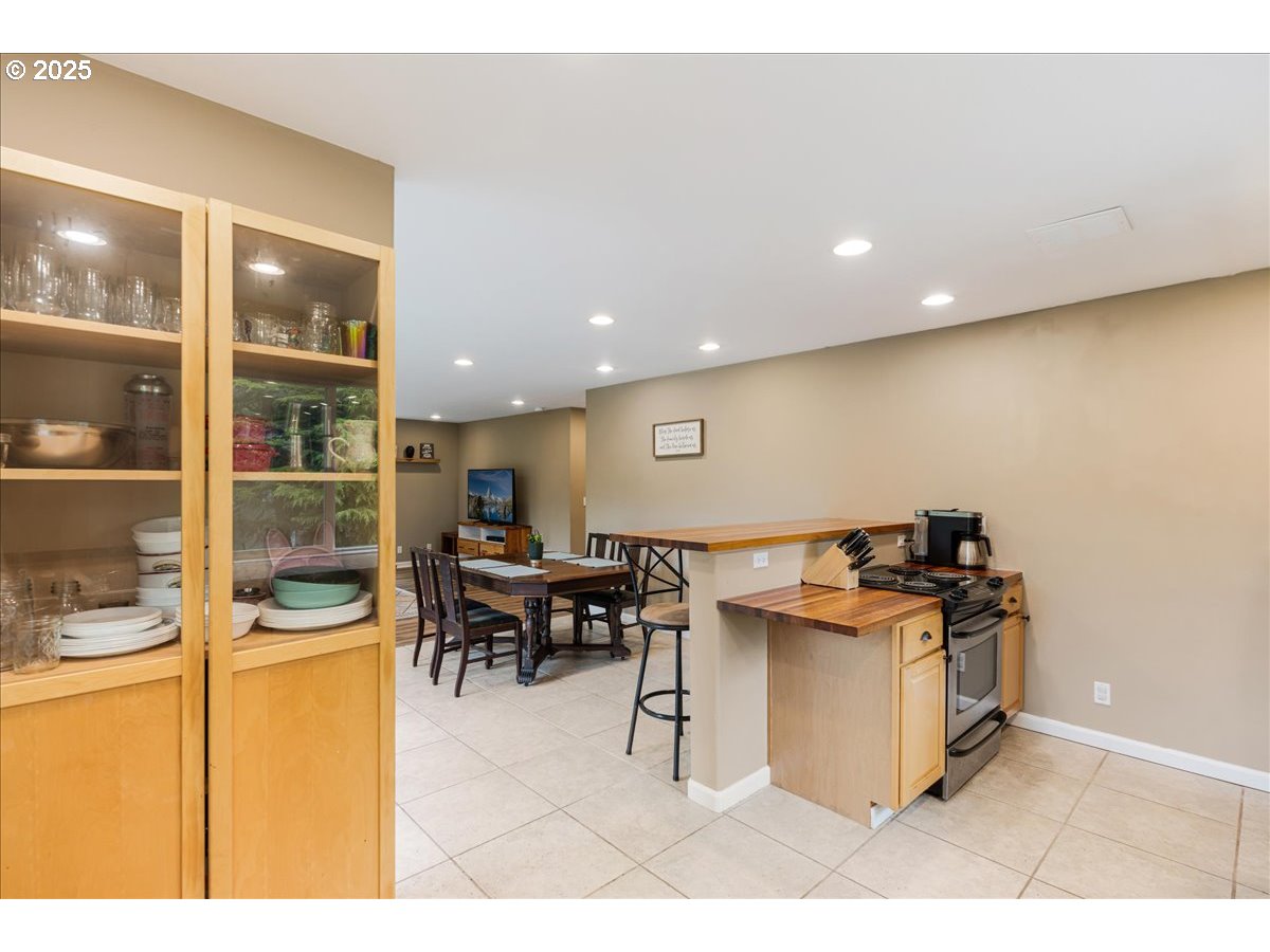 30062 Maple Drive Rainier, OR 97048 - Photo 11 of 47 a kitchen with stainless steel appliances kitchen island granite countertop a table and chairs in it