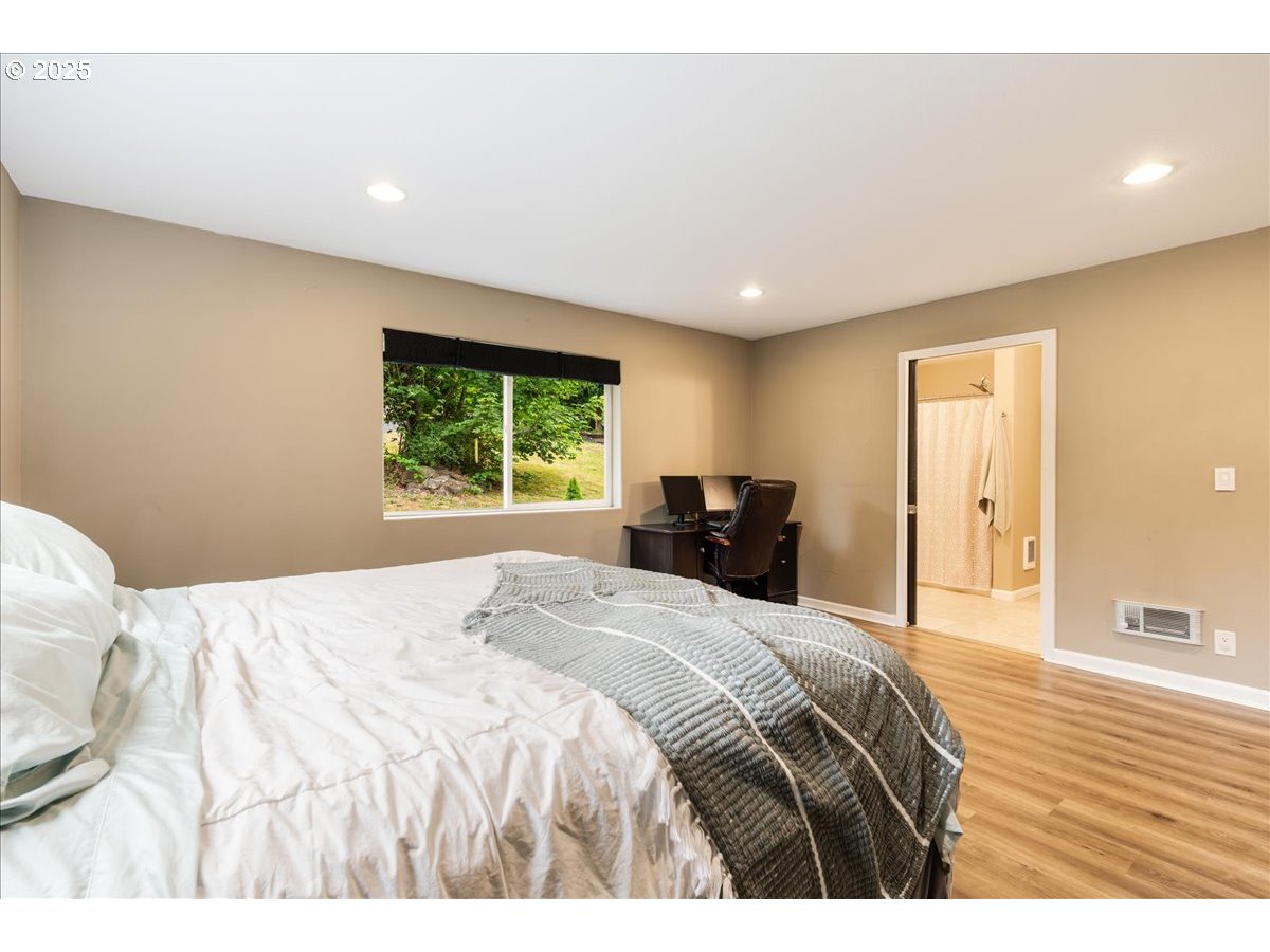 30062 Maple Drive Rainier, OR 97048 - Photo 13 of 47 a bedroom with a large bed and a large window