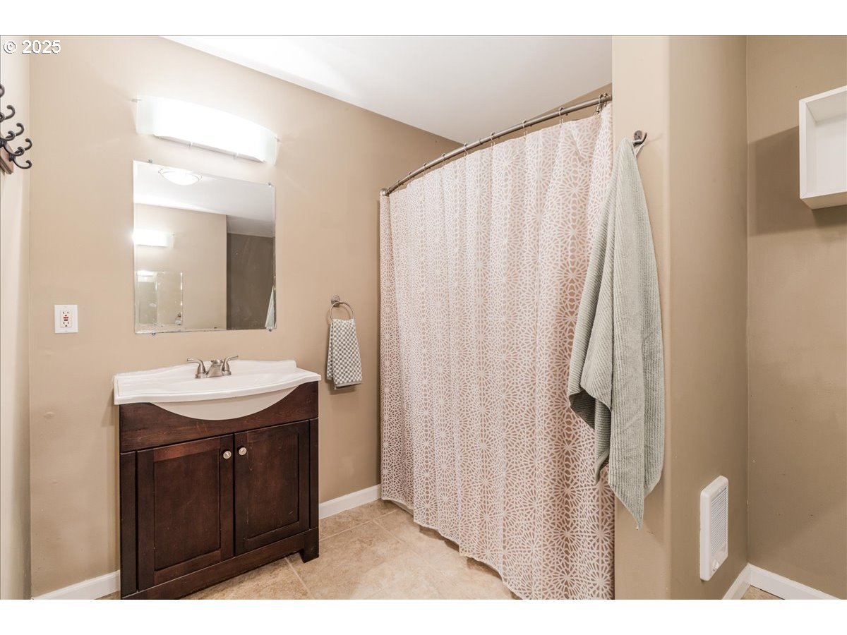 30062 Maple Drive Rainier, OR 97048 - Photo 16 of 47 a bathroom with a sink a mirror and a shower
