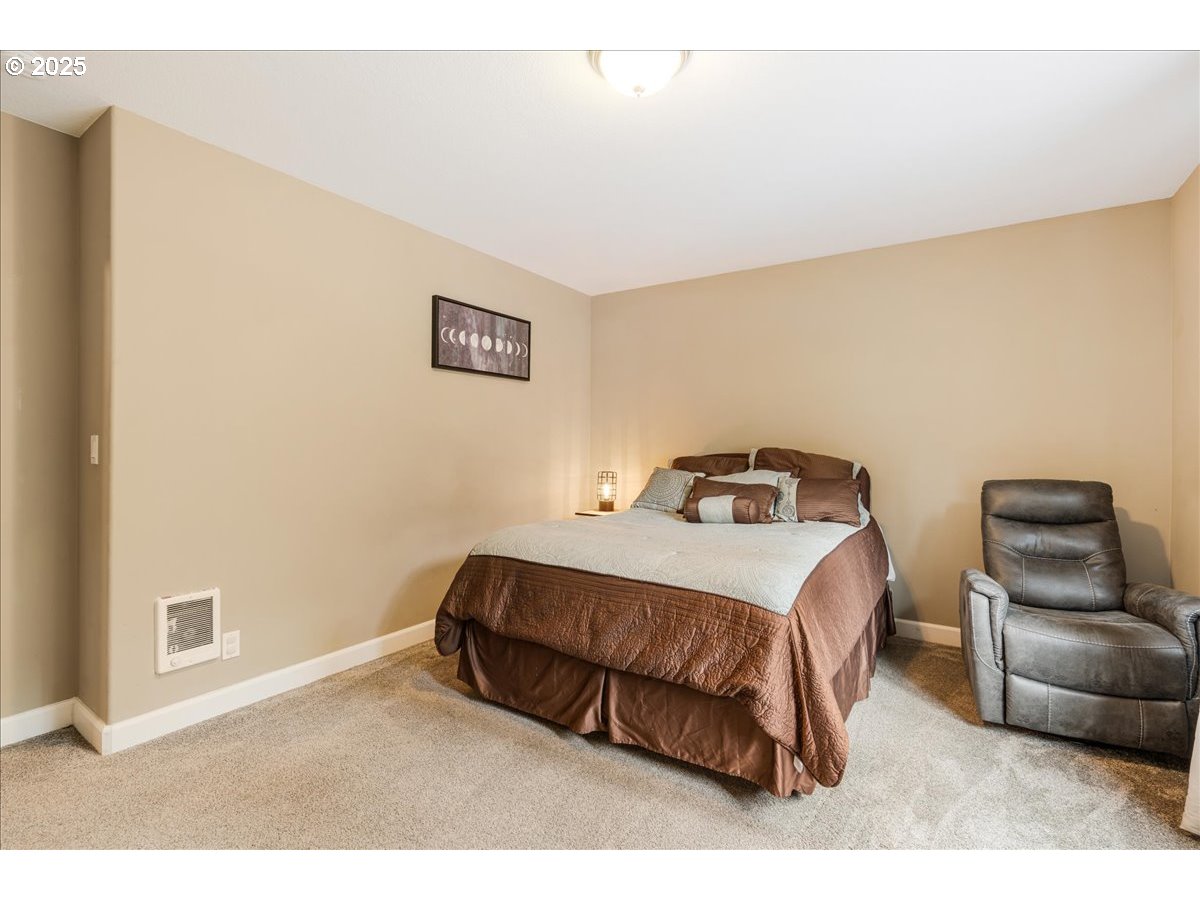 30062 Maple Drive Rainier, OR 97048 - Photo 22 of 47 a bedroom with a bed and a couch